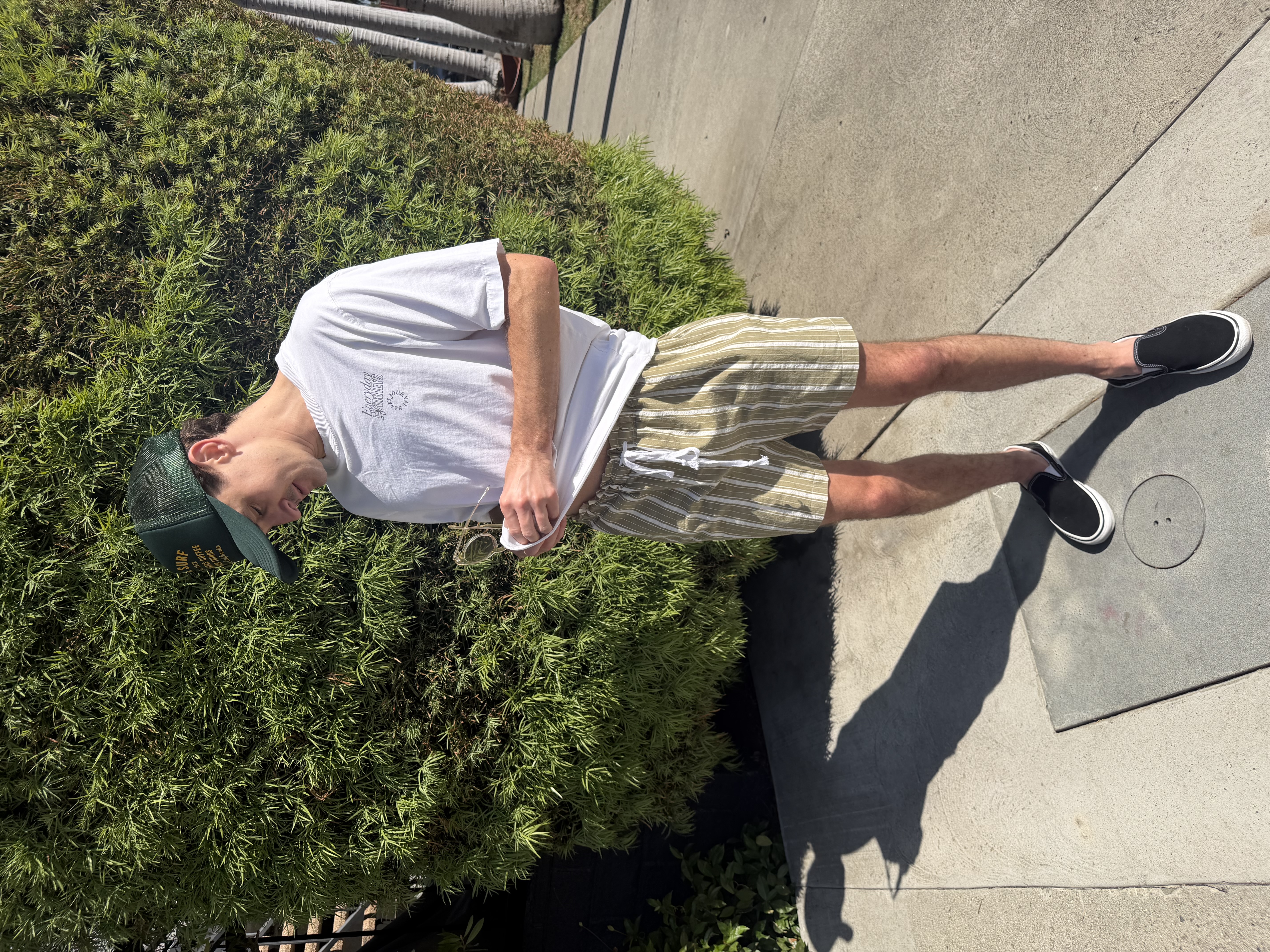 Chris adjusting his shirt outside in the finished shorts